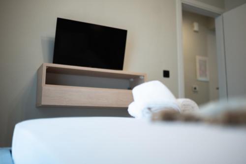 a living room with a television and a towel at Domaris Luxury Suite in Mitikas