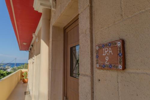 a sign on the side of a building that reads rr at Knights' Castle Studios in Archangelos