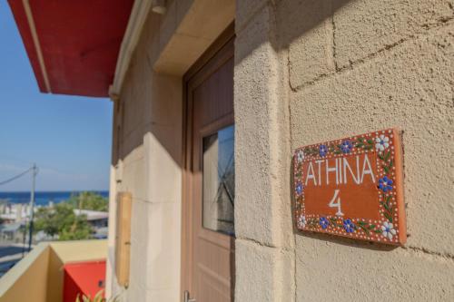 a sign on the side of a building at Knights' Castle Studios in Archangelos