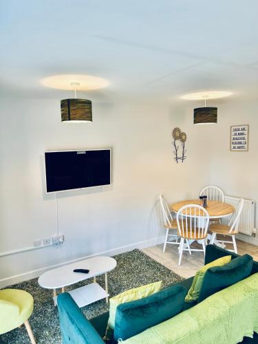 a living room with a couch and a table at Dover Ferry Apartments, private terrace and on-site parking in Dover