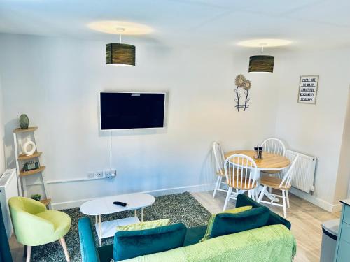 a living room with a couch and a table at Dover Ferry Apartments, private terrace and on-site parking in Dover