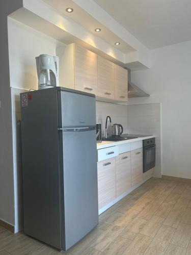 a kitchen with a refrigerator and a stove at Apartments Purkovic in Vodice