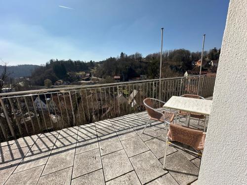 a patio with a table and chairs on a balcony at GER-Haus in Waischenfeld
