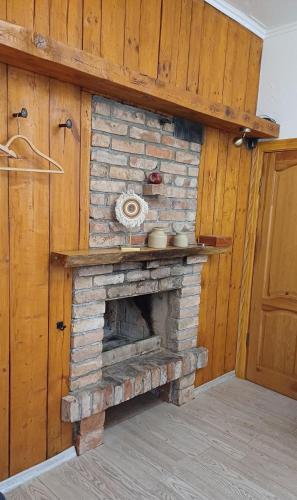 a brick fireplace in the corner of a room at Vāgnera parks in Tukums