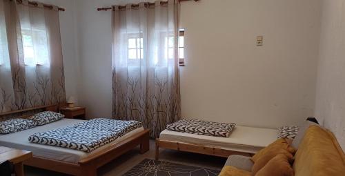 a room with two beds in a room at Vāgnera parks in Tukums