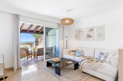 a living room with a couch and a view of the ocean at Villa Amara by Villa Plus in Chayofa