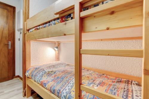 a bedroom with bunk beds in a tiny house at Sunny central studio in Morzine