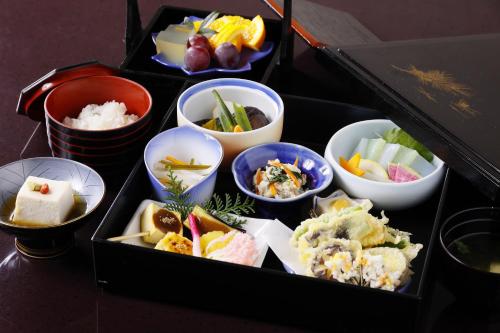 a tray filled with different types of food in bowls at 多武峰観光ホテル in Sakurai