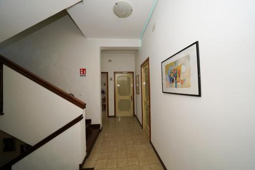 a hallway with stairs and a picture on the wall at Da Piero e Gina in Palidoro