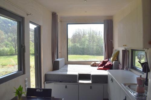 a room with a bed and a large window at Domek Mobilny w Górach Sokolich in Karpniki