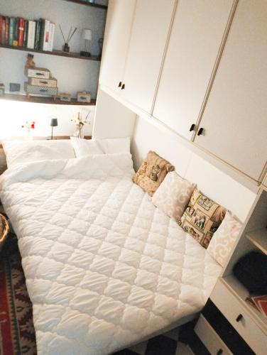 a bedroom with two beds with white sheets at Il Quadrifoglio in Arenzano