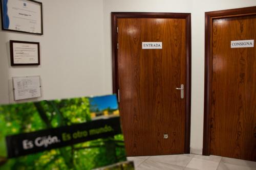 a pair of wooden doors in a room at Hotel Gijon in Gijón
