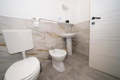 a bathroom with a toilet and a sink at Da Piero e Gina in Palidoro