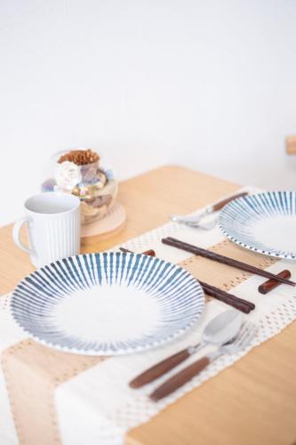 a table with two blue plates on a table at The Peak Tsutenkaku Elite in Osaka