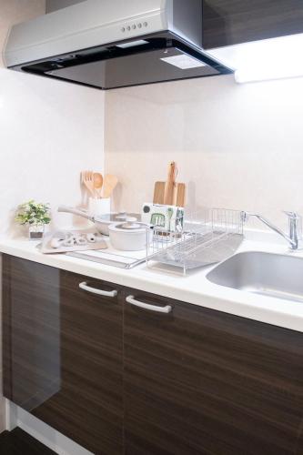a kitchen with a sink and a counter top at The Peak Tsutenkaku Elite in Osaka