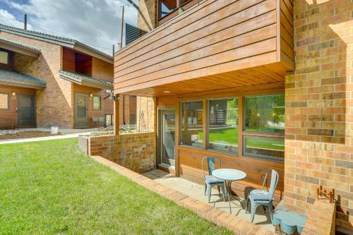 a patio with a table and chairs in a yard at Eagle-Vail Hideaway with Golf, Ski, and More! in Vail