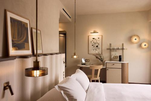 a bedroom with a bed and a table with a chair at A for Athens in Athens