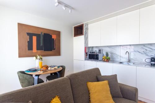 a living room with a couch and a table at ORM - Cedofeita II Apartment in Porto