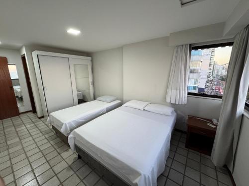 En eller flere senge i et værelse på Frente para o mar - 02 quartos