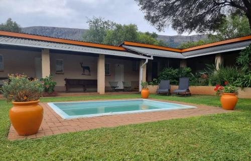 a swimming pool in the yard of a house at Harties Is Africa Safari Lodge in Hartbeespoort