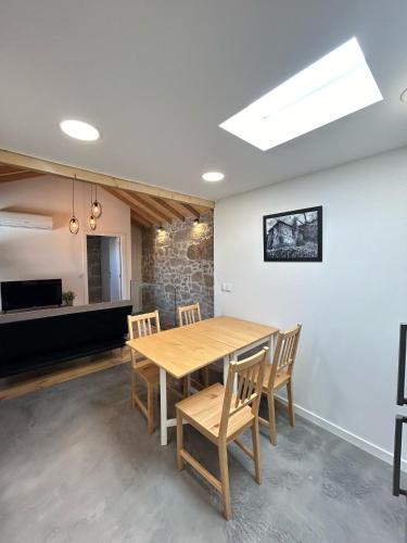 a dining room with a wooden table and chairs at Casa Laurinha by Lethes Legacy in Ponte de Lima