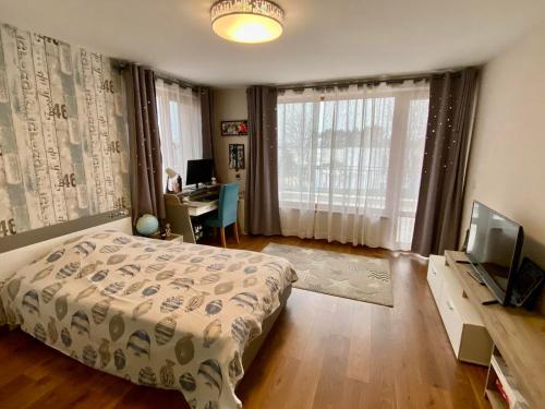 a bedroom with a bed and a desk and a television at Modern Villa with Garden in Evksinograd, Varna by Flat manаger in Varna City