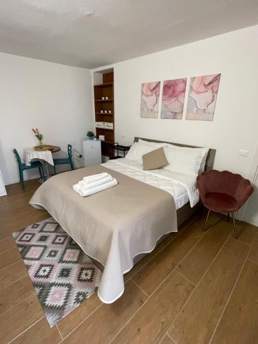a bedroom with a bed and a red chair at L&L Bed and Breakfast Malpensa Airport in Samarate