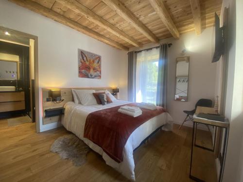 a bedroom with a large bed and a window at Du Côté de Chez Sou in Arâches-la-Frasse