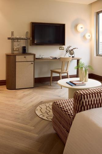 a living room with a desk and a tv at A for Athens in Athens