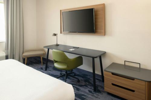 a hotel room with a desk and a television at Fairfield by Marriott Inn & Suites Scottsdale Old Town in Scottsdale