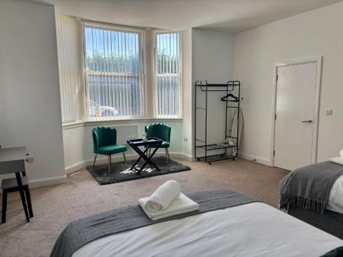 a bedroom with a bed and two chairs and a desk at The Failsworth Collection - Stylish Apartments with Free Parking in Manchester