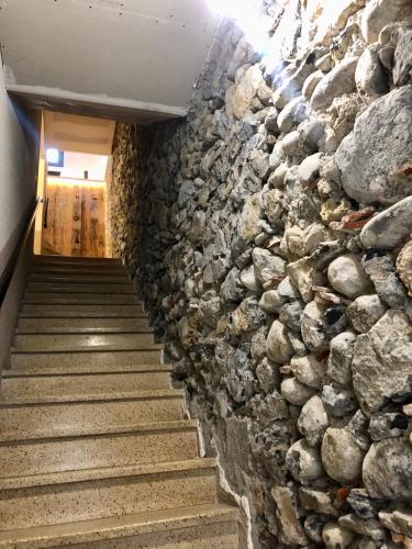 a wall of rocks next to a staircase at Le Petit Cathare, Nid rénové au cœur de Quillan in Quillan
