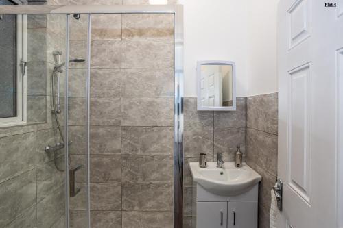 a bathroom with a shower and a sink at 1 Bed Apartments, 2 Mins to Beach, Sleeps 4 in Southend-on-Sea