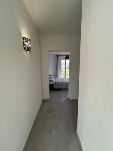 an empty hallway with a room with a bed in it at Casa Sbollazza con parcheggio e vicino al parco in Sestri Levante