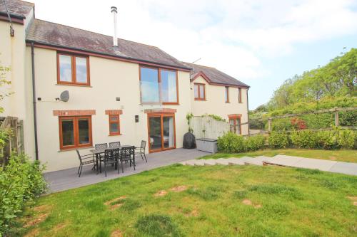 a house with a patio and a yard at Peaceful, rural cottage on the outskirts of Padstow in Padstow