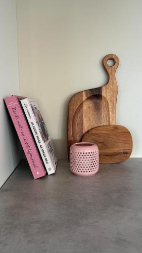 a wooden chair with two books and a pink box at Melø Panorama design home with magical views in Larvik