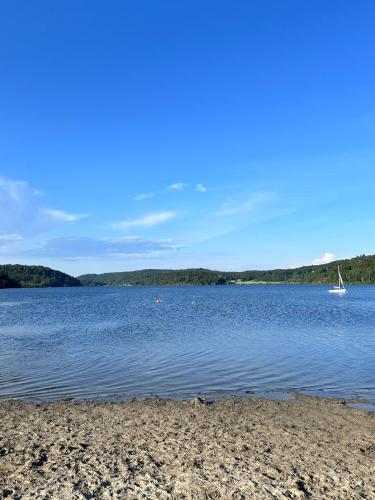 a view of a lake with a boat in the water at Melø Panorama design home with magical views in Larvik
