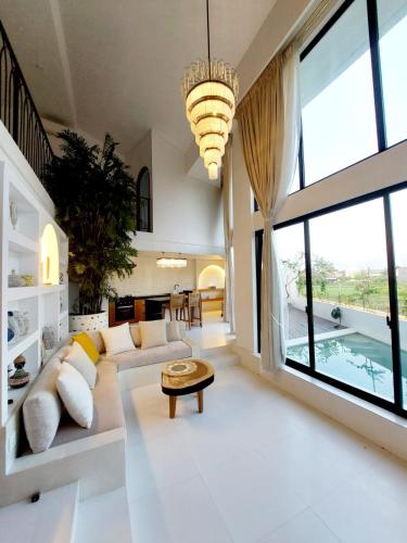 a living room with a large couch and a table at Beautiful La Shanti 1 bed villa in Kerobokan