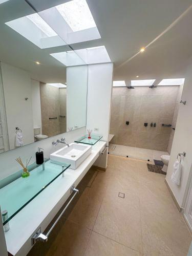 a large bathroom with a sink and a shower at A penthouse with a luxury Jacuzzi and panoramic view in Bogotá