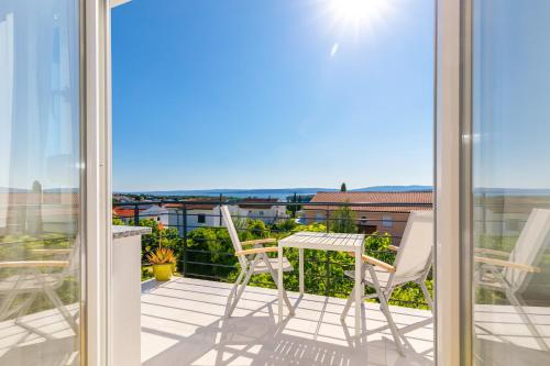 a balcony with a table and chairs and a view at Studio Point of view in Punat