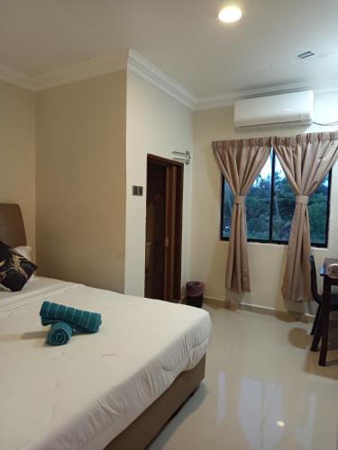 Ένα ή περισσότερα κρεβάτια σε δωμάτιο στο Hotel Pesona Timur