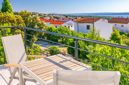 a balcony with chairs and a view of a city at Studio Point of view in Punat