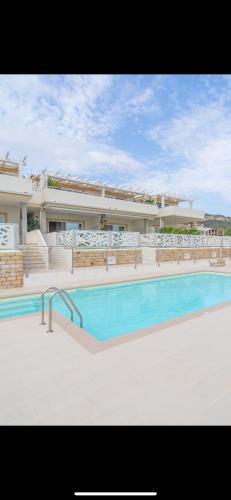 a large swimming pool in front of a building at Acqualife 3 luxury home in Arzachena