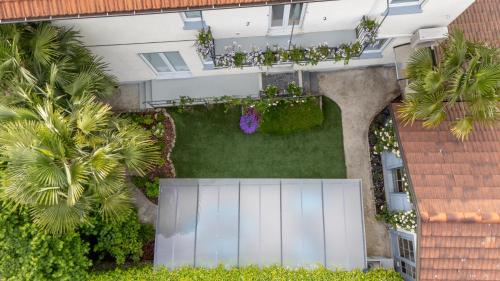 an overhead view of a garden with a white fence at Maji Como Lake in Mandello del Lario