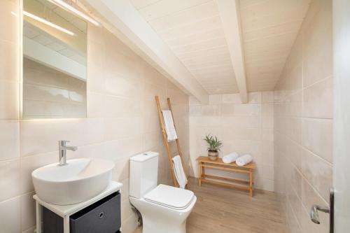 a bathroom with a sink and a toilet at Valtes Green by Vintage Travel in Corfu