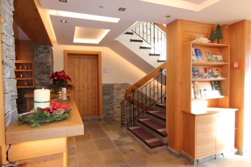 a staircase in a home with a wooden stair case at Hotel Forsthof in Sankt Johann im Pongau