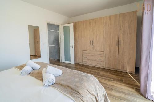 a bedroom with a large bed with two pillows at Homey 1BR home with Balcony in Heart of Malta by 360 Estates in Birkirkara