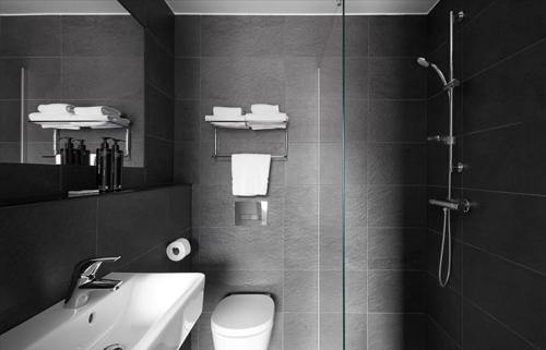 a bathroom with a shower and a toilet and a sink at The Social Hub Eindhoven Extended Stay in Eindhoven