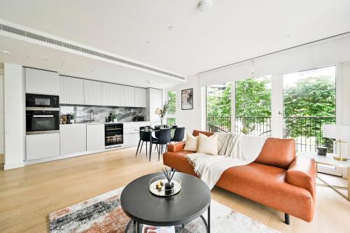 a living room with a couch and a table at Luxury 2BR Apartment - West London, Steps to Tube & Westfield Mall in London