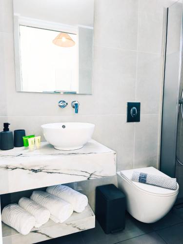 a bathroom with a sink and a toilet at Bungalows Ingrid in Tolo